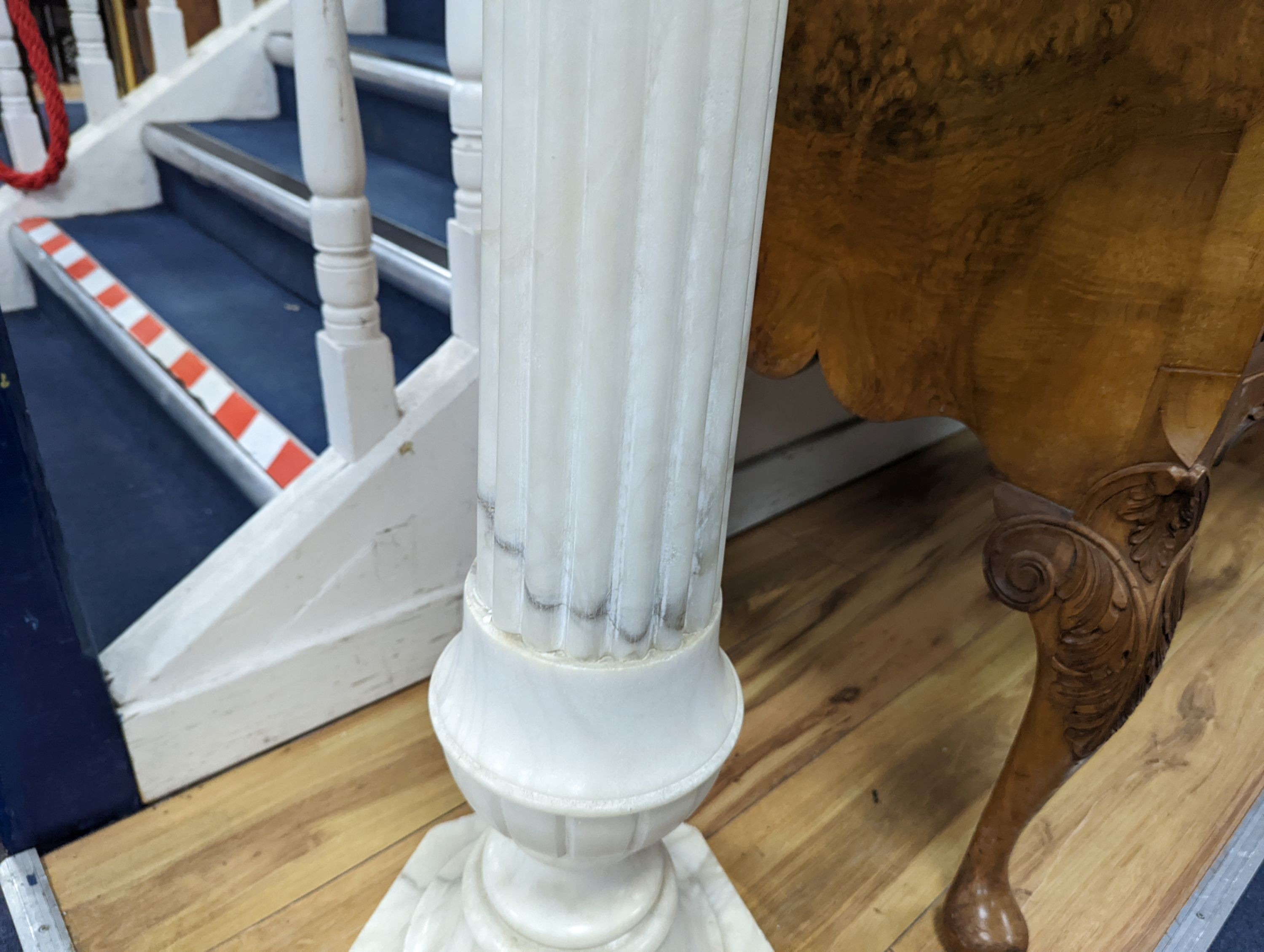 A carved alabaster pedestal on octagonal base, height 108cm